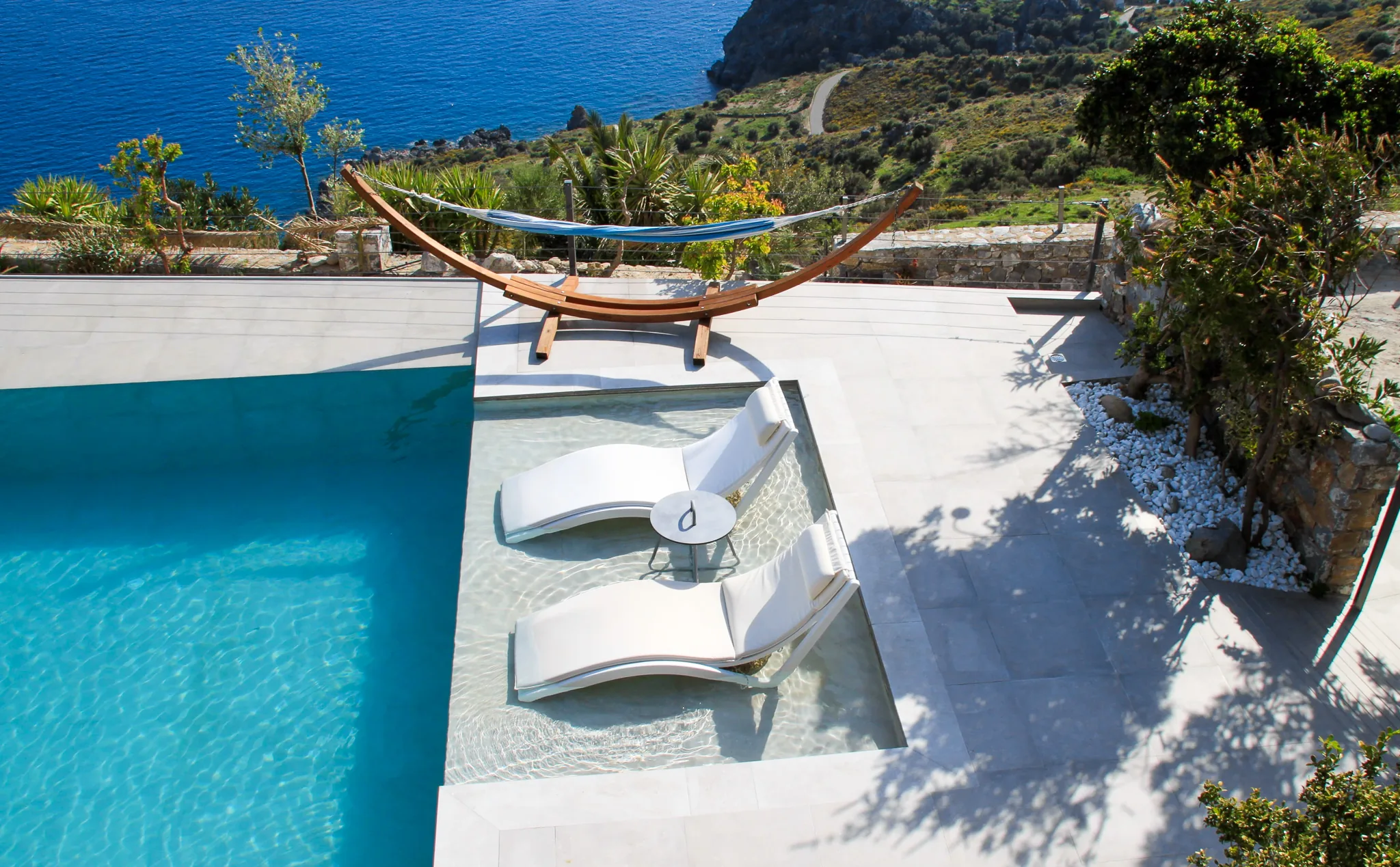 The pool terrace and hammock above the sea