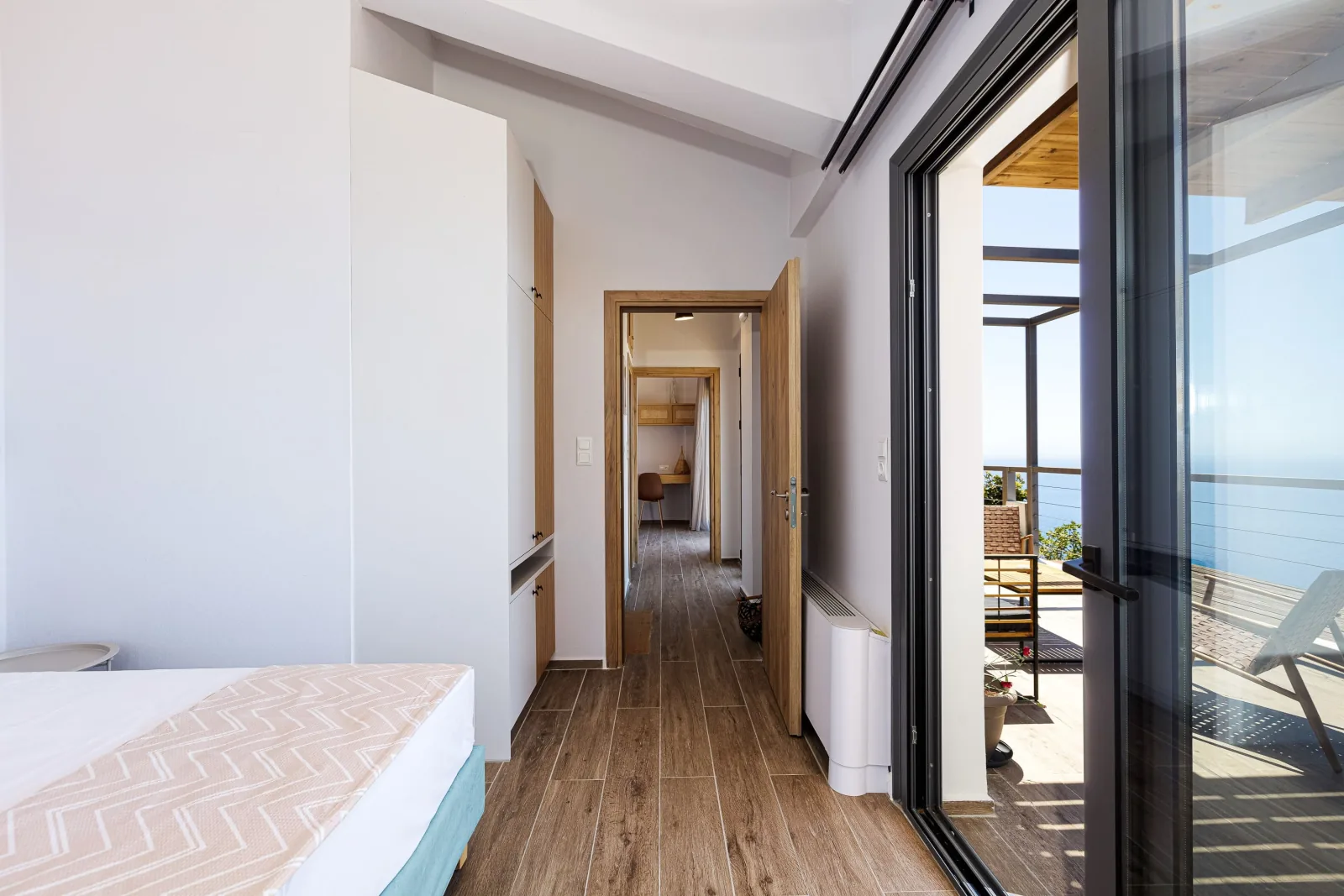 The upper-floor corridor connecting the two sea-facing bedrooms